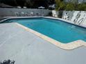 Sparkling in-ground pool surrounded by a spacious deck and white privacy fence at 4805 Oak Acres Dr, Lake Wales, FL 33898