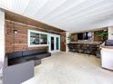 Spacious covered patio with outdoor seating, bar area, and wood accents at 4966 Foxrun Ln, Lakeland, FL 33813