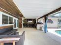 Expansive covered patio with bar seating, outdoor grill and access to the pool at 4966 Foxrun Ln, Lakeland, FL 33813