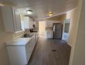 Bright kitchen features white cabinets, stainless steel appliances, and marble countertops at 5138 Rock Dove Trl, Lakeland, FL 33810