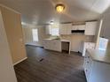 Bright kitchen with white cabinetry, marble countertops, and wood grain flooring at 5138 Rock Dove Trl, Lakeland, FL 33810