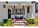 Charming front porch with brick floor and comfortable seating arrangement at 733 S Clayton Ave, Lakeland, FL 33801