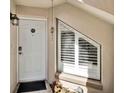 Inviting front entrance showcasing a white door, unique window, stylish light fixture, and well-maintained landscaping at 804 Magnolia Pl # 804, Winter Haven, FL 33884