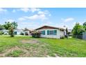 Lovely home featuring green shutters, well-kept landscaping, and a metal roof at 900 Howard Nw Ter, Winter Haven, FL 33881