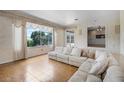 Bright living room featuring a large window, tile flooring, and a spacious sofa at 900 Howard Nw Ter, Winter Haven, FL 33881