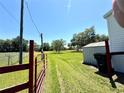 Expansive backyard with grass, a shed, and a fence, perfect for outdoor activities at 9625 Moore Rd, Lakeland, FL 33809