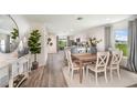Open-concept dining room with stylish table set and hardwood floors at 2242 Majestic Span Ave, Eagle Lake, FL 33839