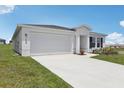 Well-maintained single-story home with a two-car garage, clean landscaping, and a long driveway at 3528 Dahlia Dr, Haines City, FL 33844
