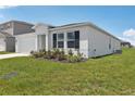 Attractive single-story home with neat landscaping, dark shutters, and a well-maintained lawn at 3528 Dahlia Dr, Haines City, FL 33844