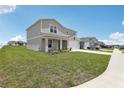Charming two-story home with a well-maintained lawn and a two car garage at 3508 Dahlia Dr, Haines City, FL 33844