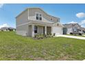 Charming two-story home with a well-maintained lawn and a two car garage at 3508 Dahlia Dr, Haines City, FL 33844