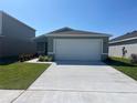 Charming single-story home featuring a two-car garage, neat landscaping, and a well-maintained lawn at 2366 Aquiline Nest St, Eagle Lake, FL 33839