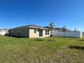 Spacious backyard with lush green grass and a new white privacy fence at 2374 Aquiline Nest St, Eagle Lake, FL 33839