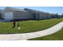 Well-manicured front yard showcases the home's landscaping and curb appeal at 2374 Aquiline Nest St, Eagle Lake, FL 33839