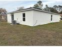 Rear view of a single-story house with AC unit at 2322 Sw 146Th Loop, Ocala, FL 34473