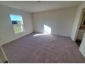 Spacious bedroom with carpeted floor and large window at 13012 Se 53Rd Ave, Belleview, FL 34420