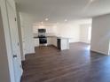 Modern kitchen with stainless steel appliances and dark laminate floors at 13012 Se 53Rd Ave, Belleview, FL 34420