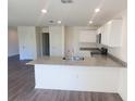 Modern kitchen with granite countertops and stainless steel sink at 13012 Se 53Rd Ave, Belleview, FL 34420