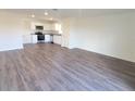 Open-concept living area with modern flooring that flows into a bright, functional kitchen at 13001 Se 53Rd Ave, Belleview, FL 34420