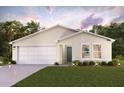 Tan single story home with a two car garage and manicured lawn at 12966 Se 53Rd Ave, Belleview, FL 34420