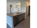Modern kitchen island with stainless steel appliances and open layout to living area at 10776 Sw 49Th Ave, Ocala, FL 34476