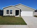 Well-maintained single-story home with manicured lawn and attached two-car garage at 2408 Nw 22Nd Ct, Ocala, FL 34475