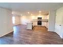 Open-concept kitchen with stainless steel appliances, granite countertops, and a central island at 2408 Nw 22Nd Ct, Ocala, FL 34475
