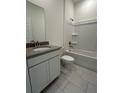 Bright bathroom featuring a single sink vanity and a shower-tub combination at 5530 Sw 103Rd St Rd, Ocala, FL 34476