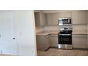Modern kitchen with stainless steel appliances and gray cabinets at 1807 Don Pl, Poinciana, FL 34759
