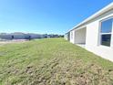 Spacious backyard view showcasing the home's exterior and surrounding new construction neighborhood at 2491 Nw 23Rd Ave, Ocala, FL 34475