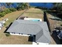 Aerial view showcasing a single-story house, backyard pool, and lakefront location at 35 Alicante Rd, Debary, FL 32713