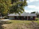 Beautiful brick home with attached garage, manicured lawn, and mature tree providing shade at 1223 Lawrence Ave, Deltona, FL 32725