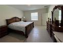 Cozy main bedroom features a large window for natural light and ample closet space at 5640 Sw 117Th Lane Rd, Ocala, FL 34476