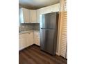 Kitchen features white cabinetry, updated countertops, and stainless steel refrigerator at 3123 Crystal Hills Dr, Lakeland, FL 33801