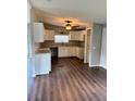 Spacious kitchen with white cabinets, laminate countertops, ceiling fan, and wood-look flooring at 3123 Crystal Hills Dr, Lakeland, FL 33801