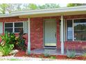 Charming brick home with tiled entryway and well maintained landscaping at 5801 Poinciana Ave, Lakeland, FL 33809