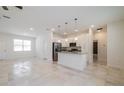 Open-concept kitchen with stainless steel appliances, granite countertops, and a central island at 421 Arkansas Ct, Poinciana, FL 34759
