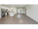 Open concept living space featuring modern kitchen, wood floors and plenty of natural light at 13 Haddock Way, Poinciana, FL 34759