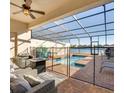 Relaxing screened pool area boasts brick pool deck, blue tiled pool, outdoor seating and dining area at 8882 Geneve Ct, Kissimmee, FL 34747
