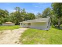 A charming single-story home with a well-maintained lawn and inviting side entrance at 1143 Ne 23Rd St, Ocala, FL 34470