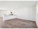 Spacious living room with new wood floors and an open layout to the kitchen at 2228 Oklahoma Dr, Sumterville, FL 33585