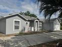 Charming single Gathering home featuring light-grey stucco siding and protective bars on windows at 1152 Mccormick Dr, Deltona, FL 32725