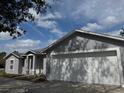 Charming single Gathering home with a two car garage and light-grey colored stucco siding at 1152 Mccormick Dr, Deltona, FL 32725