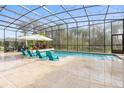 Enclosed pool area with lounge chairs and landscaping at 109 La Toscana Rotonda, Ormond Beach, FL 32174