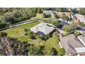 Aerial view of the property showcasing a large, landscaped yard with screened-in lanai and neighborhood at 112 Sevilla Ct, Poinciana, FL 34759