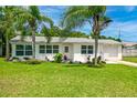Charming single story home with a well-manicured lawn and lush landscaping at 45 San Jose Dr, Ormond Beach, FL 32176