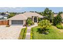 Single-Gathering home exterior with well-manicured lawn and paver driveway at 3 Seabridge Dr, Ormond Beach, FL 32176