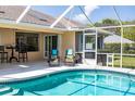 Relaxing pool area with screened enclosure and patio furniture at 3 Seabridge Dr, Ormond Beach, FL 32176