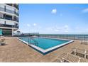 Beautiful beachfront pool with lounge chairs and ocean views in this resort style living community at 1239 Ocean Shore Blvd # 7E5, Ormond Beach, FL 32176