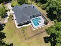 Aerial view of a secluded home featuring a screened pool and a large backyard with secure fencing at 5701 John Anderson Hwy, Flagler Beach, FL 32136
